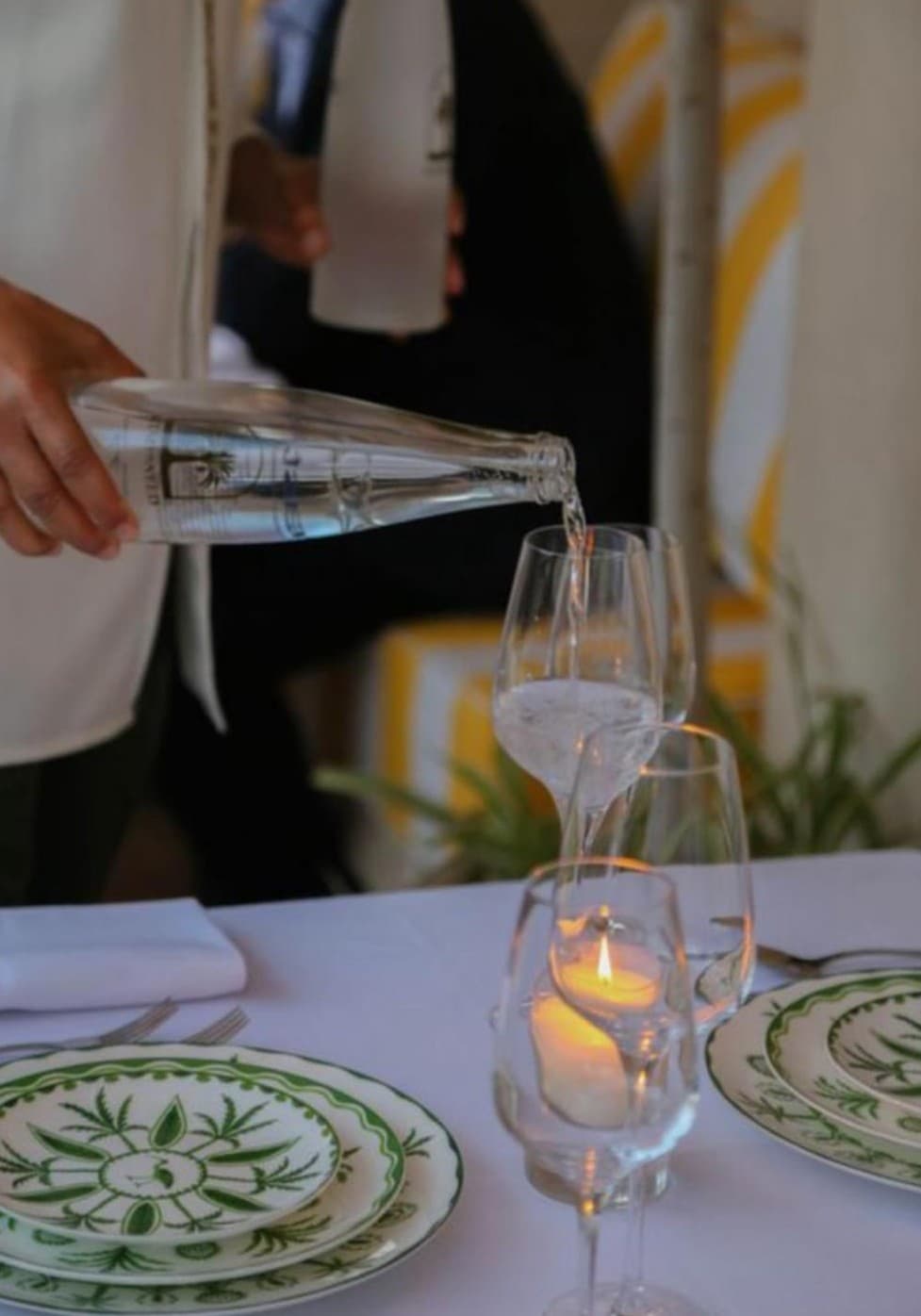 Sommelier pouring water at dinner