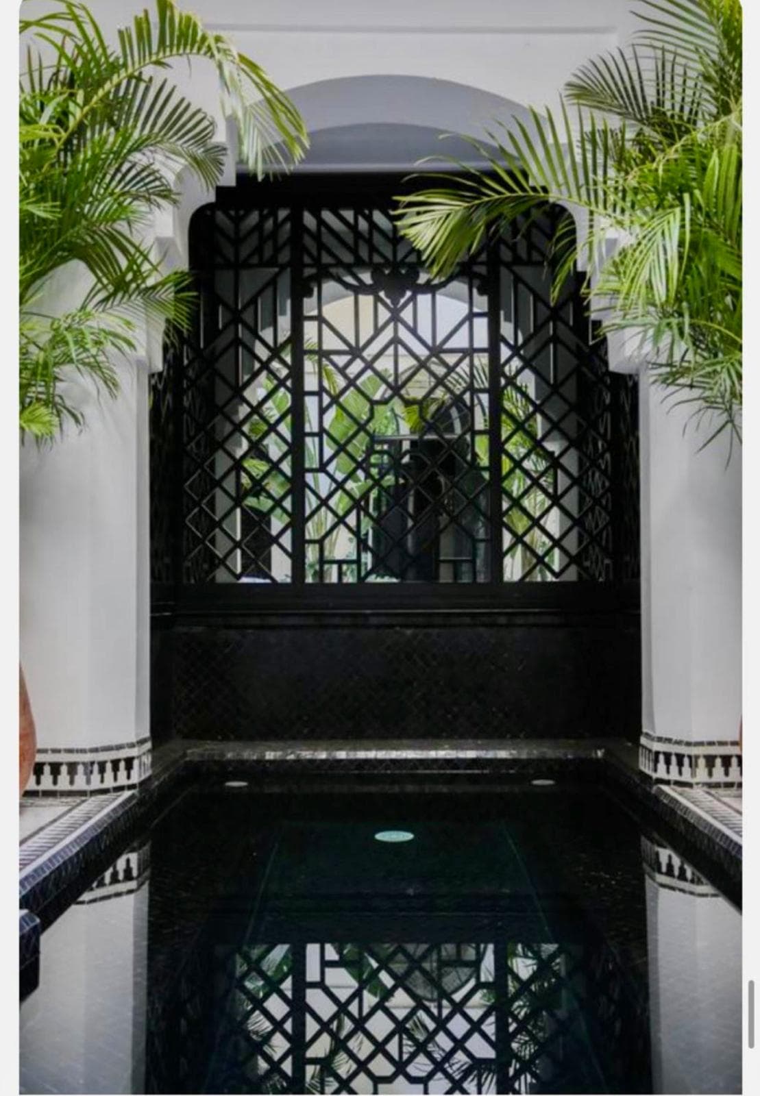 Indoor pool with wrought-iron screen