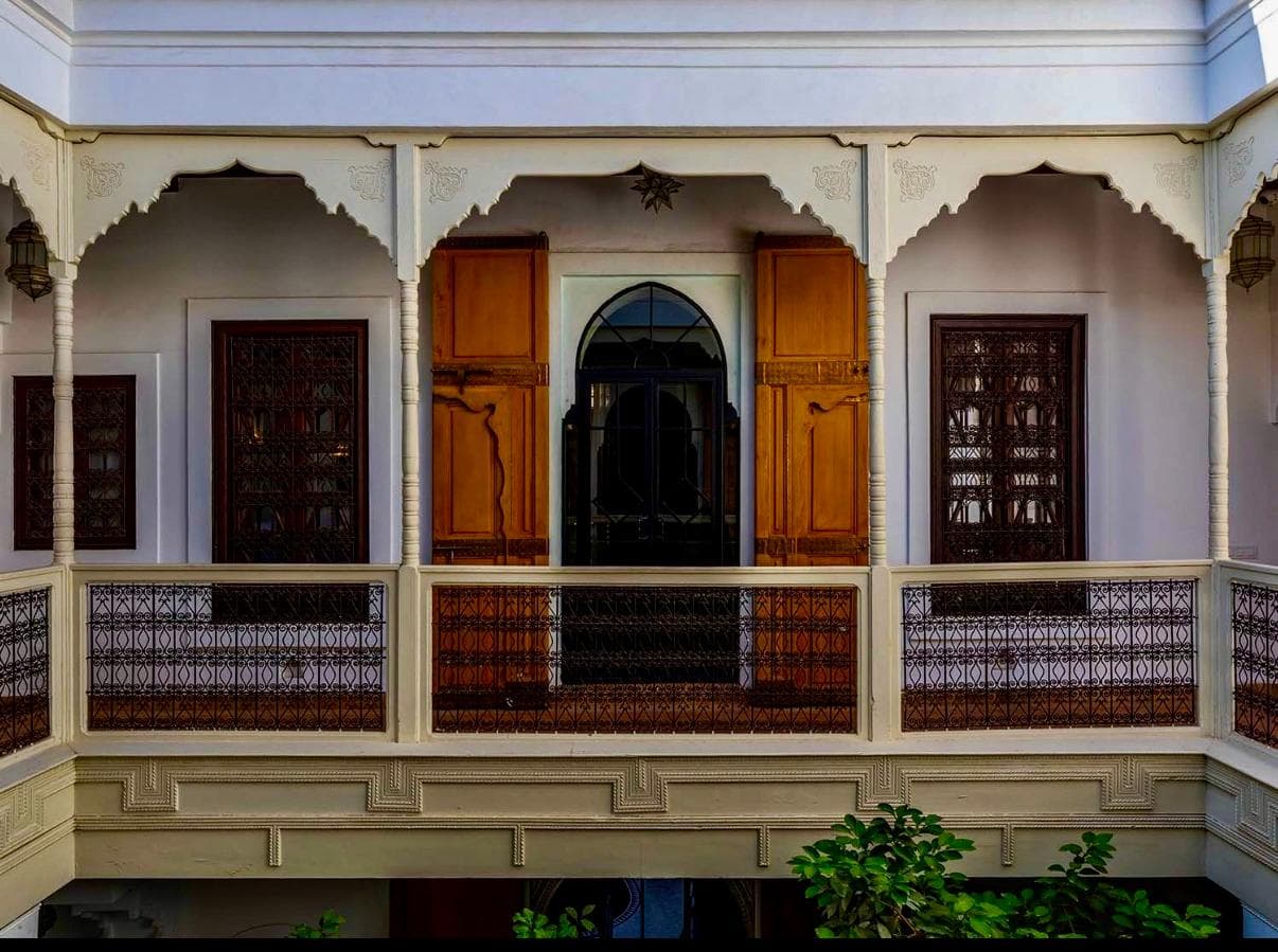 Arched balconies and wrought-iron railings