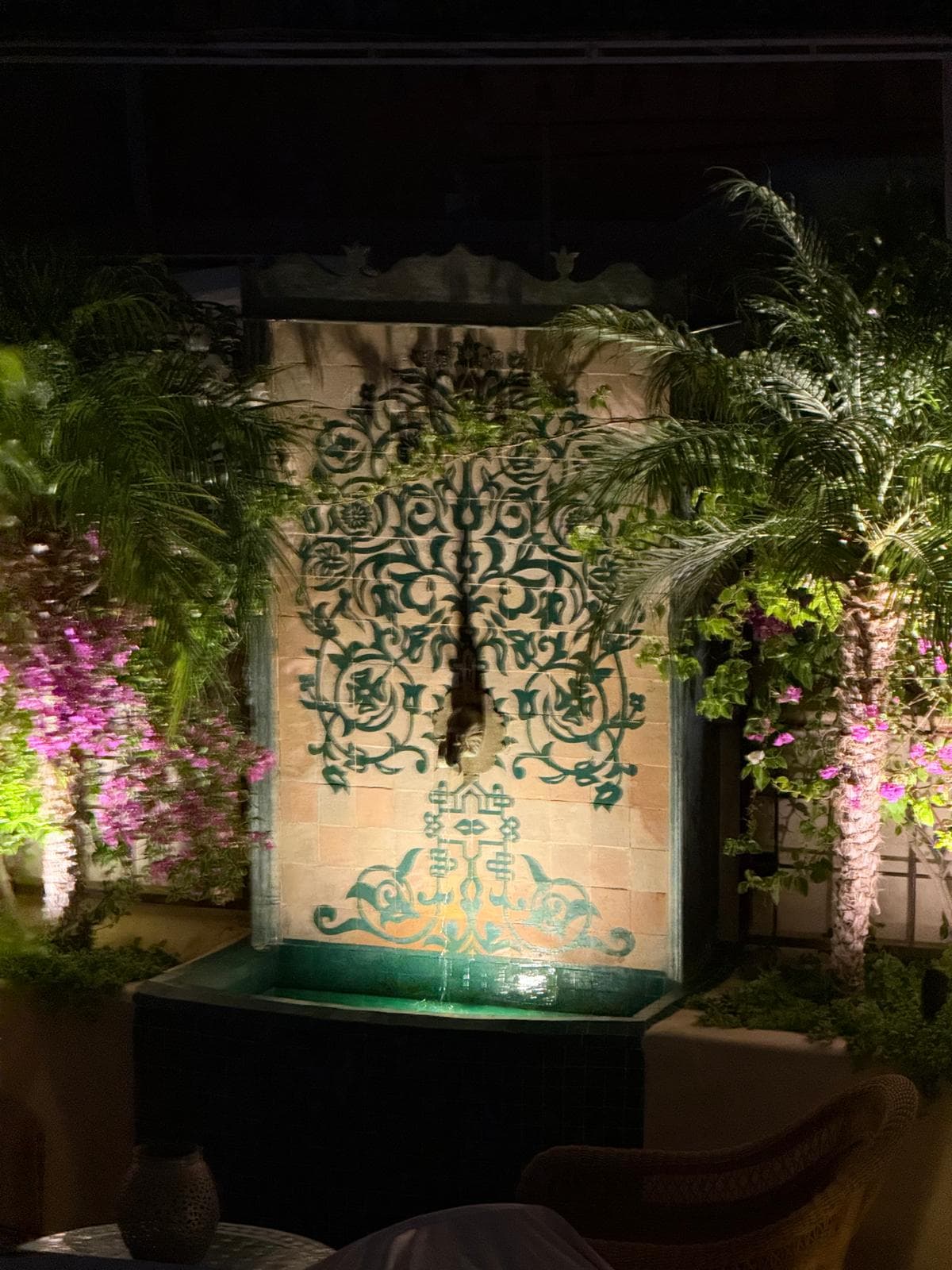 Fountain glowing among lit gardens